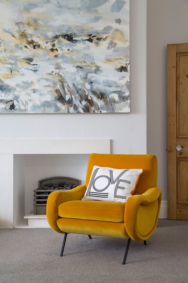 Yellow velvet armchair with modern art canvas in Brighouse living room West Yorkshire UK