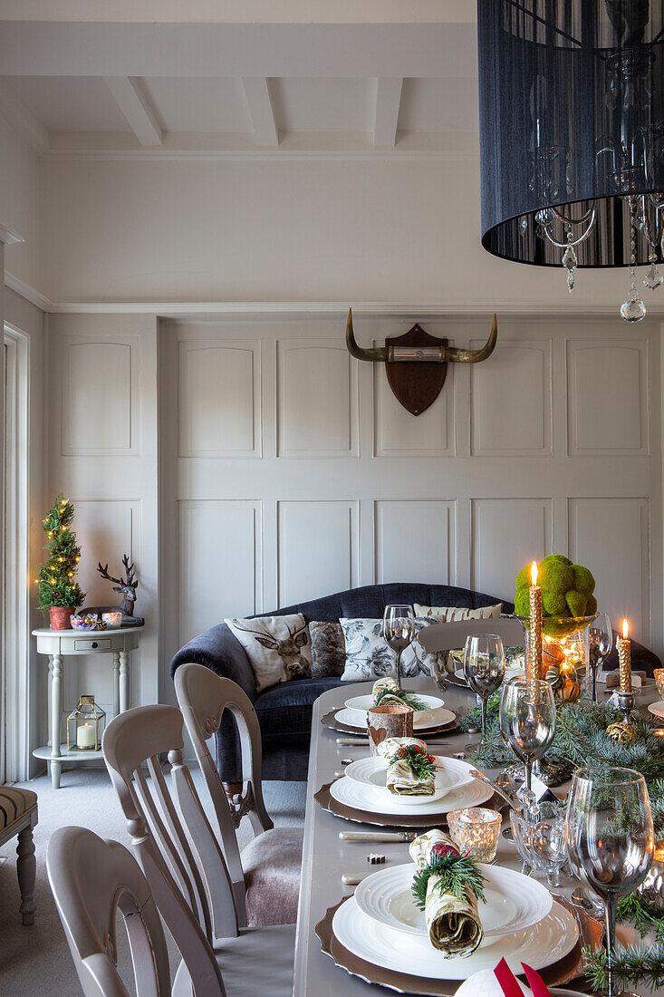 Lit candles on dining table at Christmas in 1890s Victorian villa Liverpool