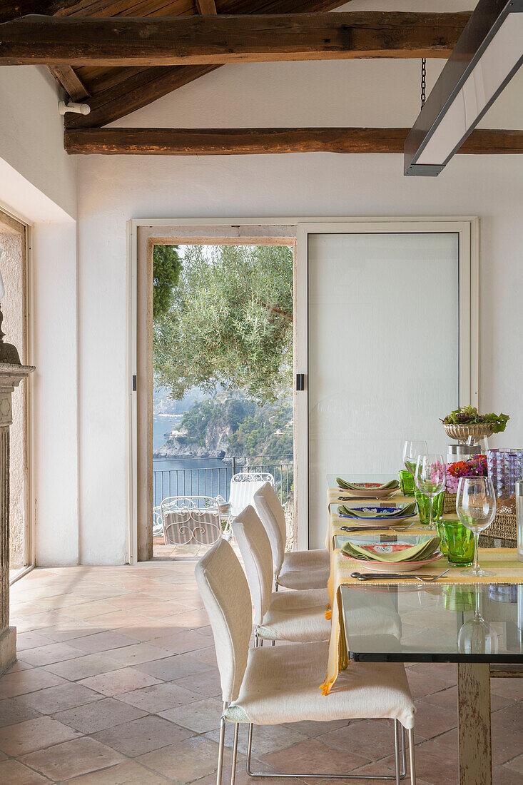 Glass topped dining table with view to sea from coastal villa Amalfi Italy