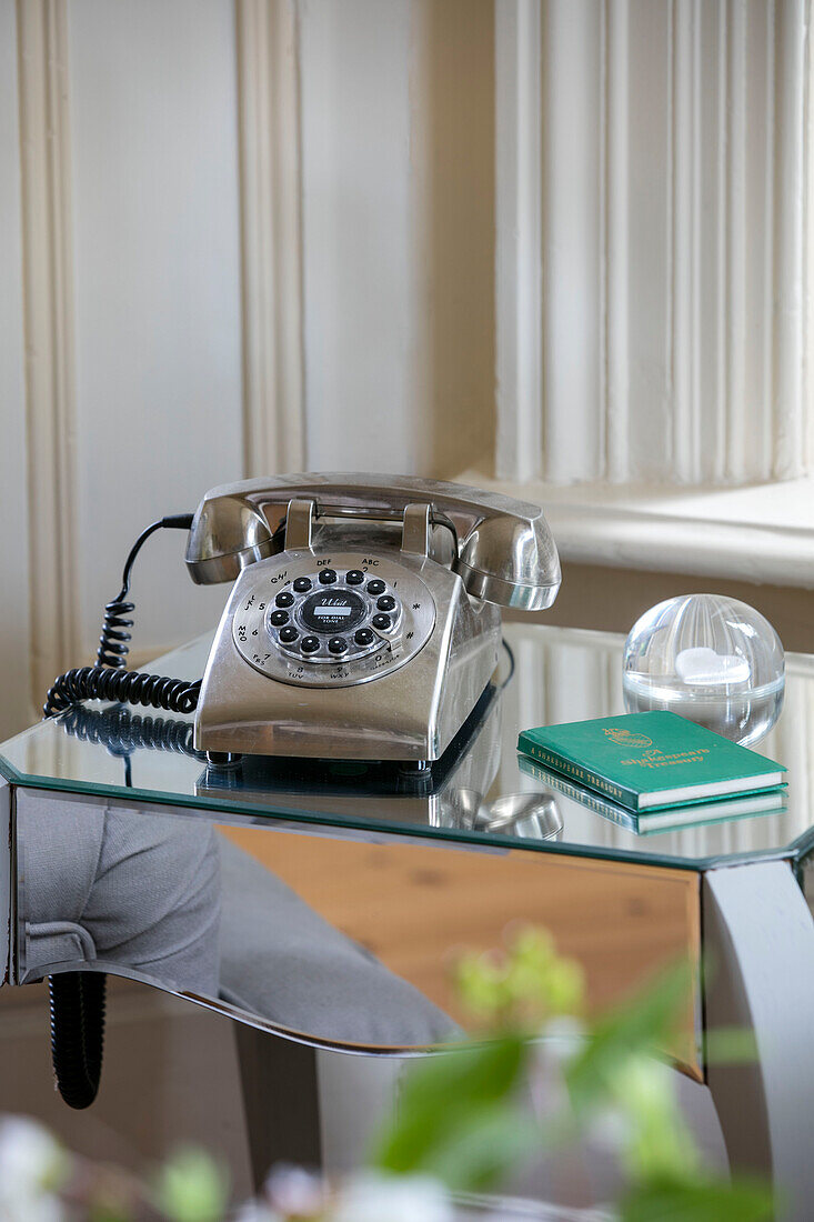 Rotary dial telephone on mirrored side table in detached Kent home UK