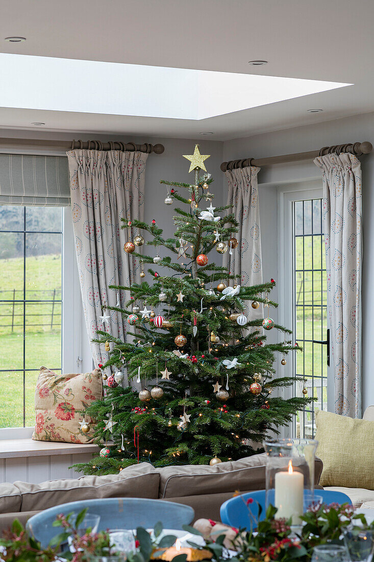 Christmas tree in corner of 1930s Arts and Crafts home West Sussex UK