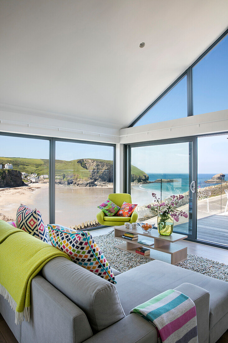 Living room with colourful furnishings and sea view Cornwall UK
