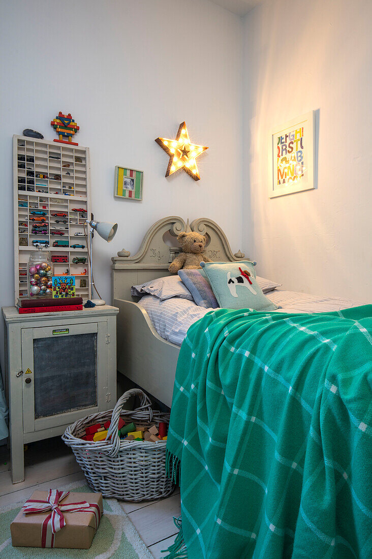 Vintage printers tray toy storage on bedside cabinet in boys room of Norwich home Norfolk UK