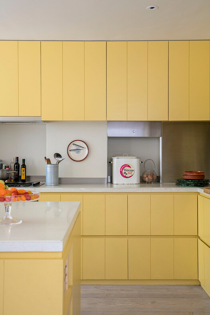 Breadbin in yellow fitted kitchen of London home UK