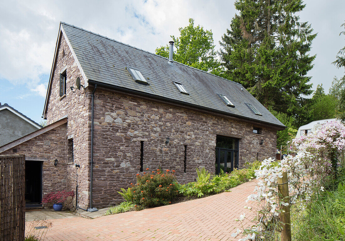 Brick driveway and stone exterior of Monmouthshire barn conversion Wales UK