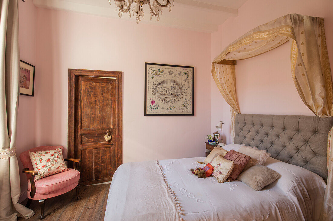 Embroidered cushions and canopy on double bed in Issigeac townhouse Perigord France