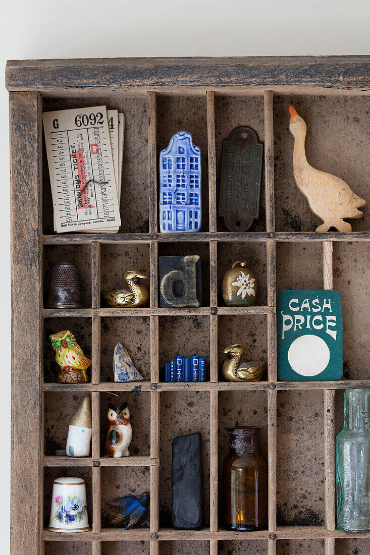 Ornaments and trinkets in old printer's tray Derbyshire UK