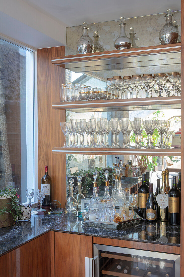 Glassware on shelves in drinks cabinet of London home UK