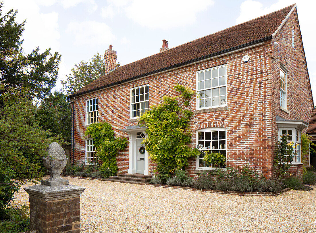 Driveway entrance and facade of Georgian style country house Hampshire UK