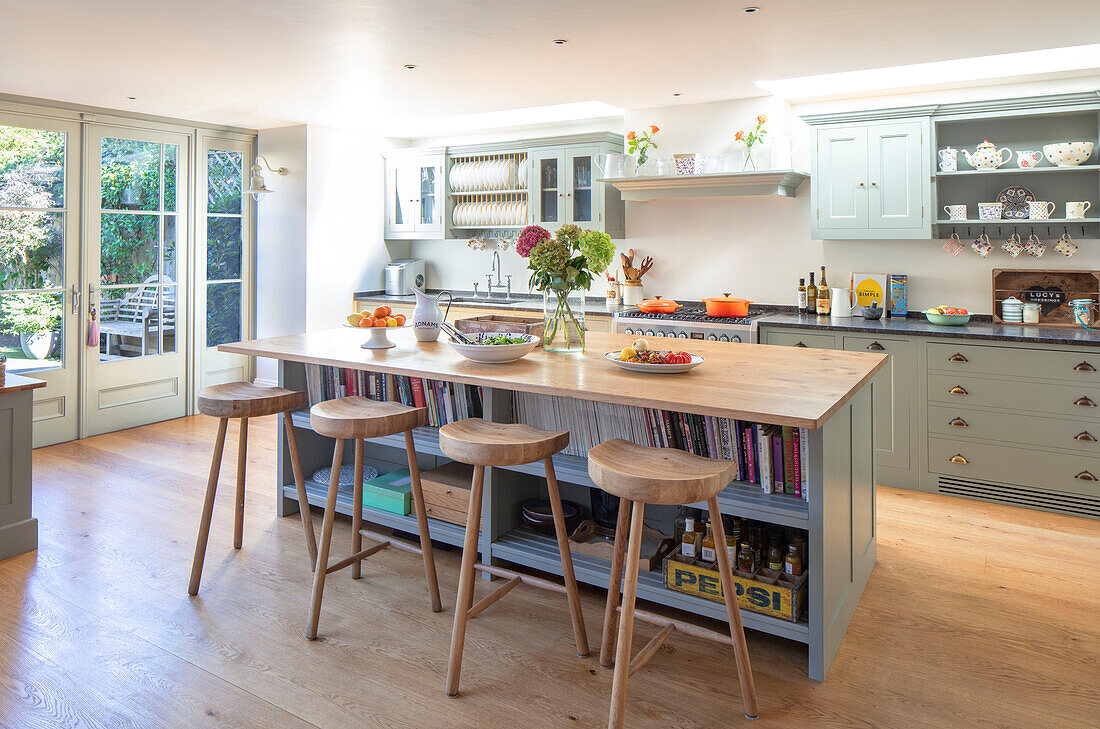 Kitchen island with wooden bar stools and recipe books Southwest London UK