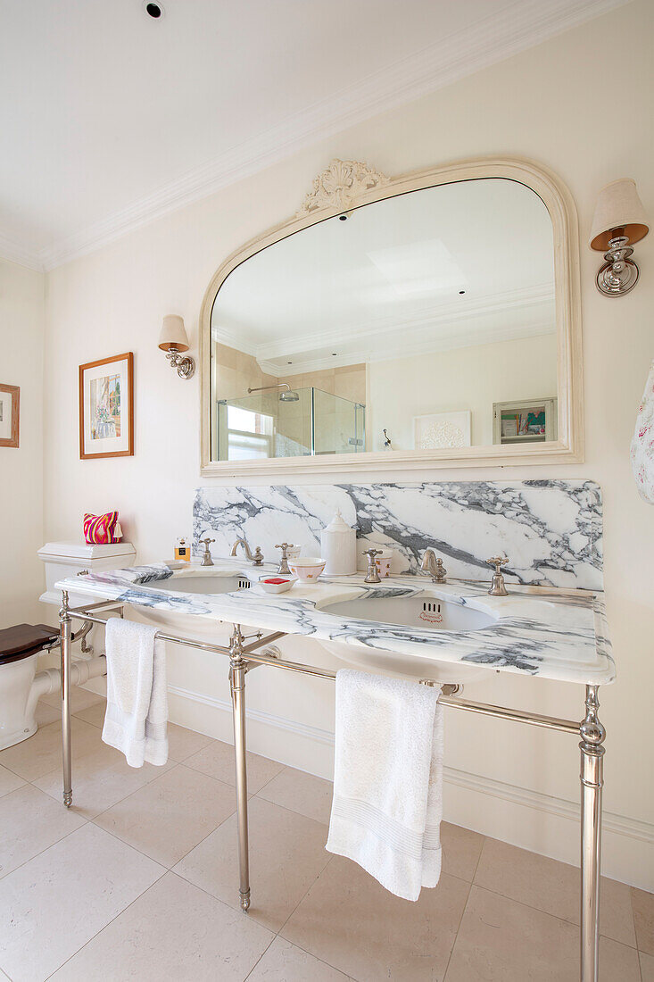 Large mirror above double washbasin in Southwest London home UK