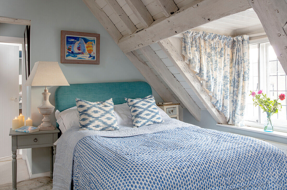 Attic bedroom in blues and whites Grade II listed Georgian country house West Sussex UK