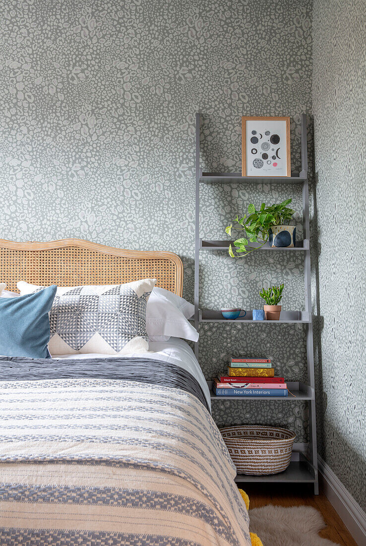 Plants and books on freestanding bedside shelving unit Sussex UK