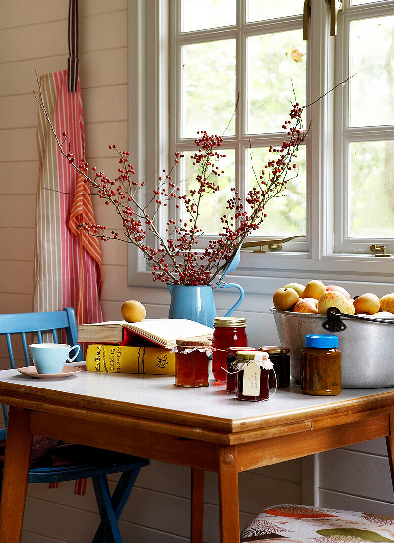 Twig arrangement and jam with apples on kitchen table at window in Isle of Wight home UK