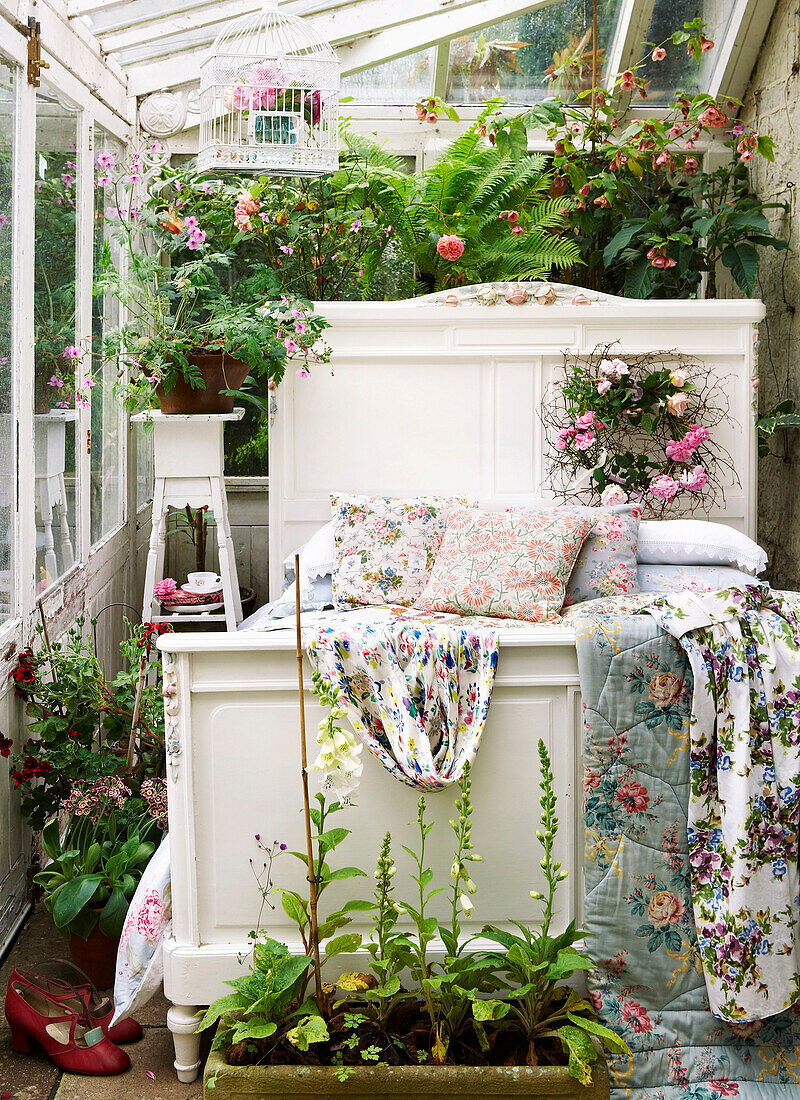 White single bed with floral quilts in conservatory of Isle of Wight home UK