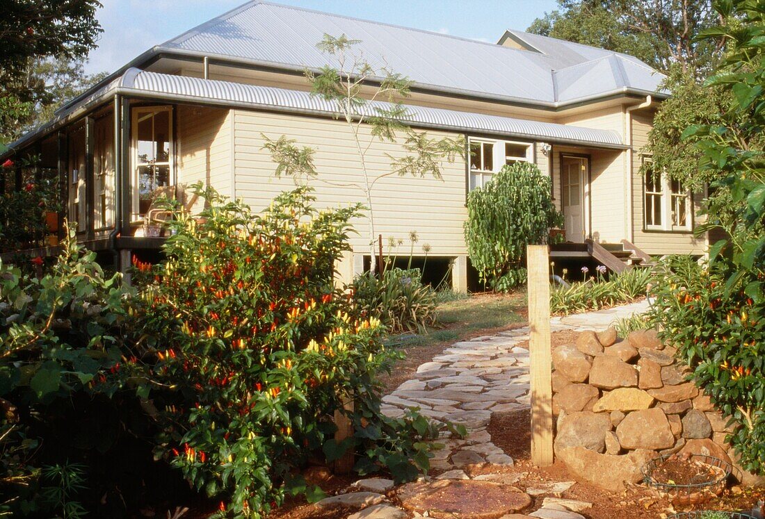 Exterior and garden of a colonial style bungalow with veranda 