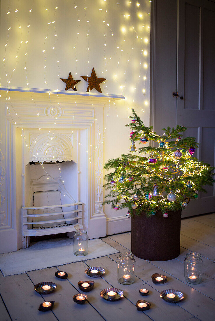 Miniature Christmas tree with vintage baubles and baking tea lights