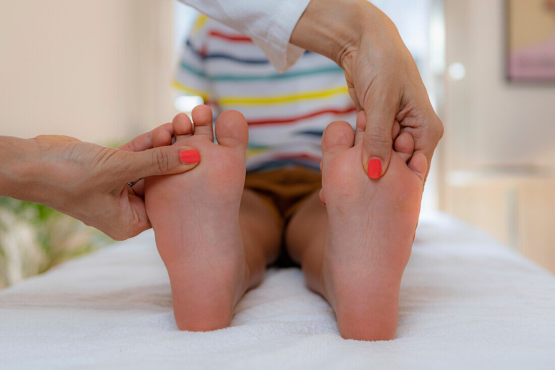 Pediatrician examining a boy's feet