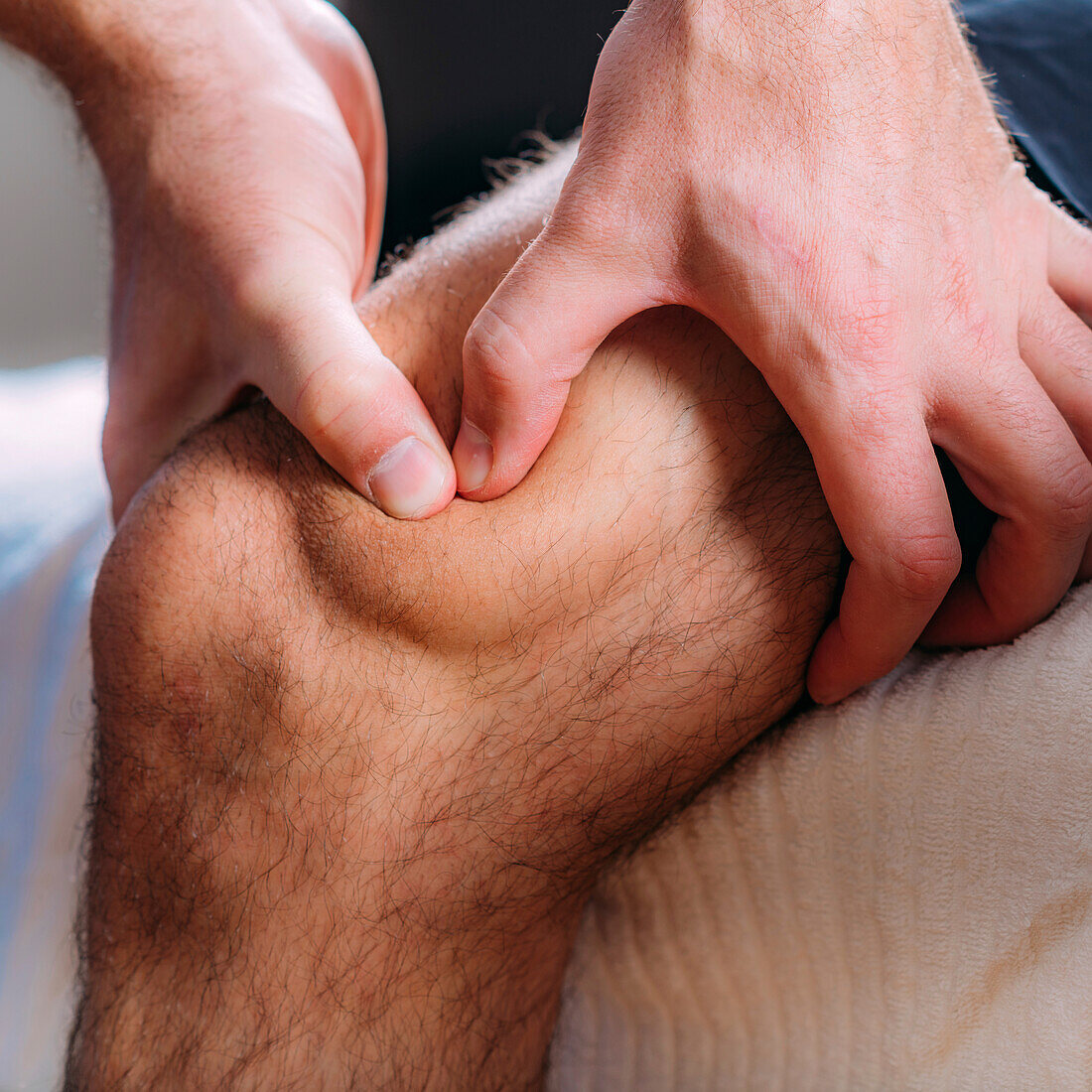 Physiotherapist massaging an injured knee