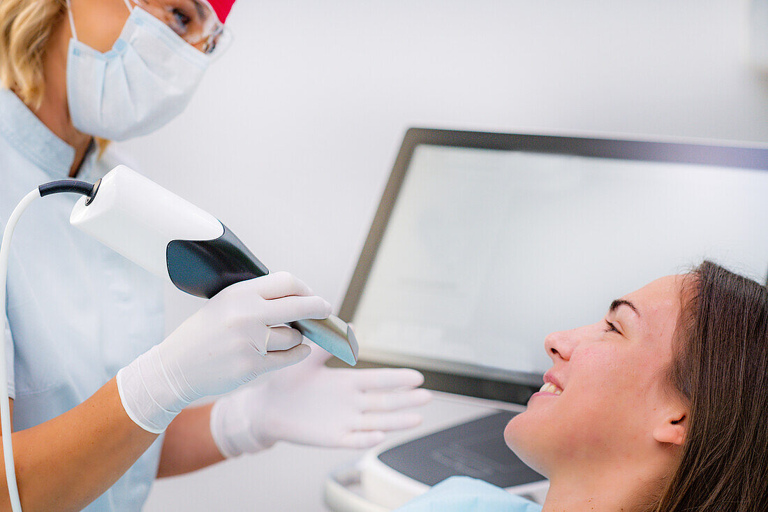 Dentist using 3D dental camera for scanning teeth