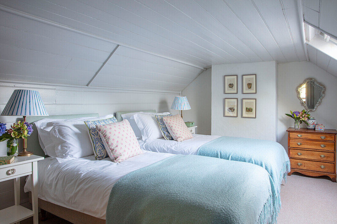 Two twin sized beds in a bright attic room