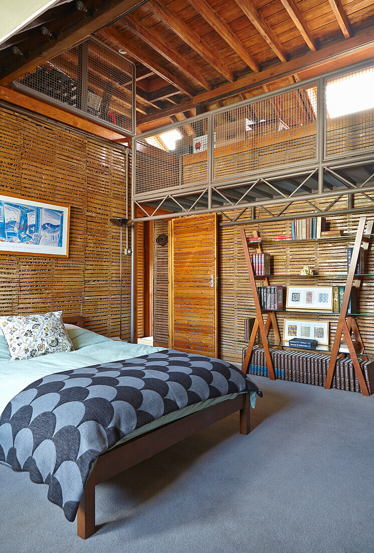 Double bed in a room with high ceilings