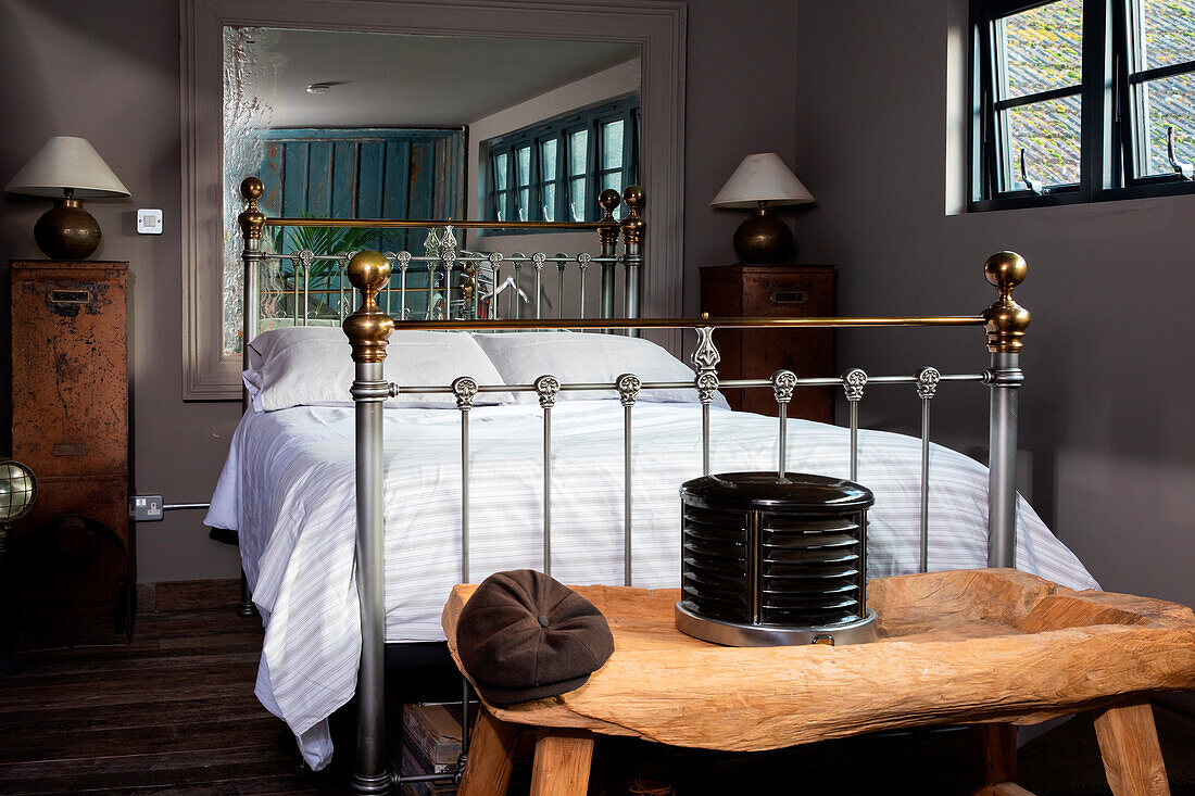 Carved wooden bench by the double bed in the bedroom