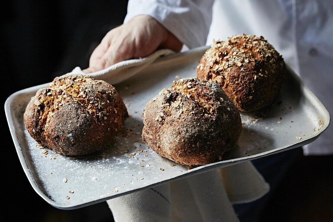 Fresh crusty bread on an oven tray