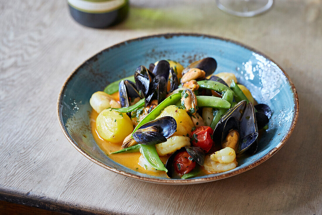 Seafood stew with mussels, mange tout and potatoes