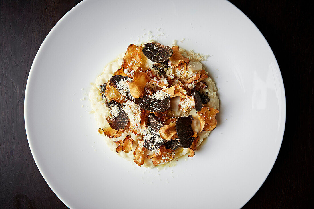 Risotto with truffle shavings and parsnip chips