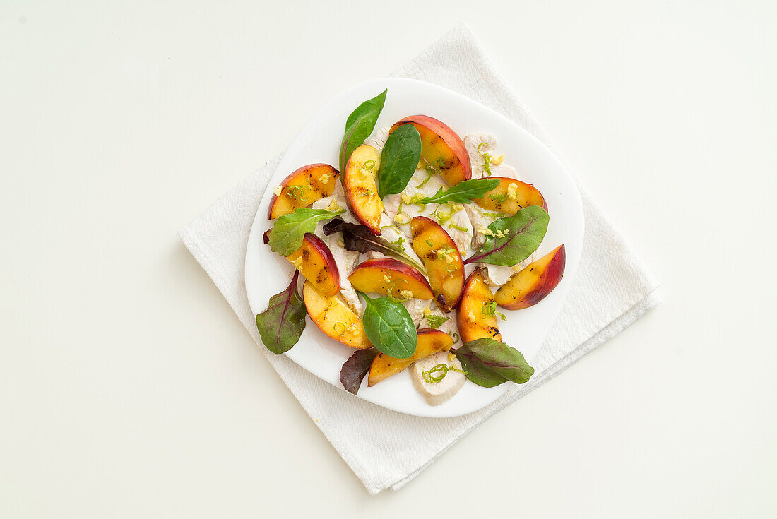 Peach and ginger salad on chicken breast
