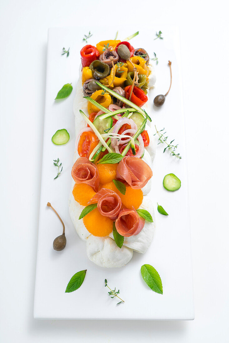 Mozzarella with colourful toppings (vegetables, ham, melon)