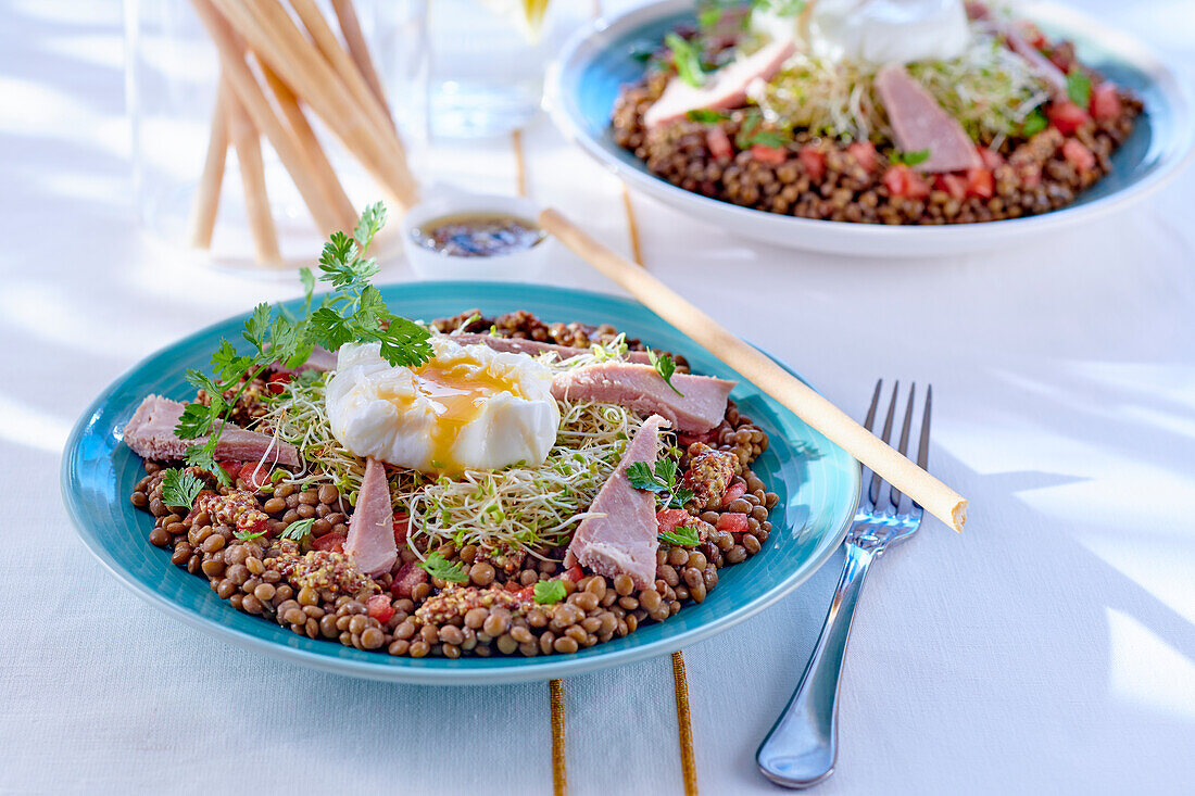 Lentil salad with poached egg, ham and sprouts