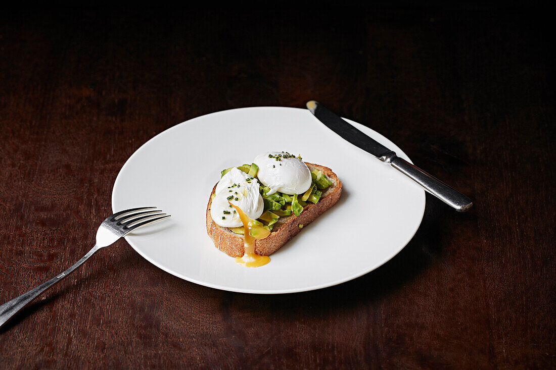 Pochierte Eier mit Avocado auf Sauerteig-Brot