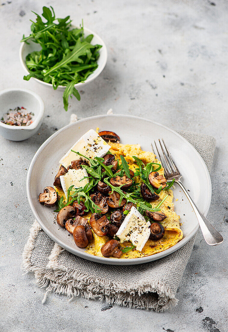 Omelette mit gebratenen Pilzen und Rucola