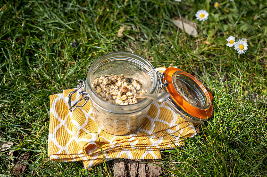 Bircher muesli in a glass on a meadow