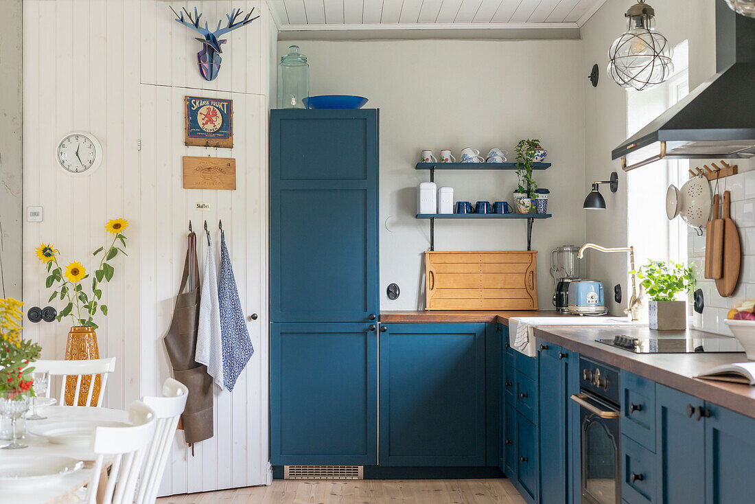 Country kitchen with blue cabinets and sunflowers