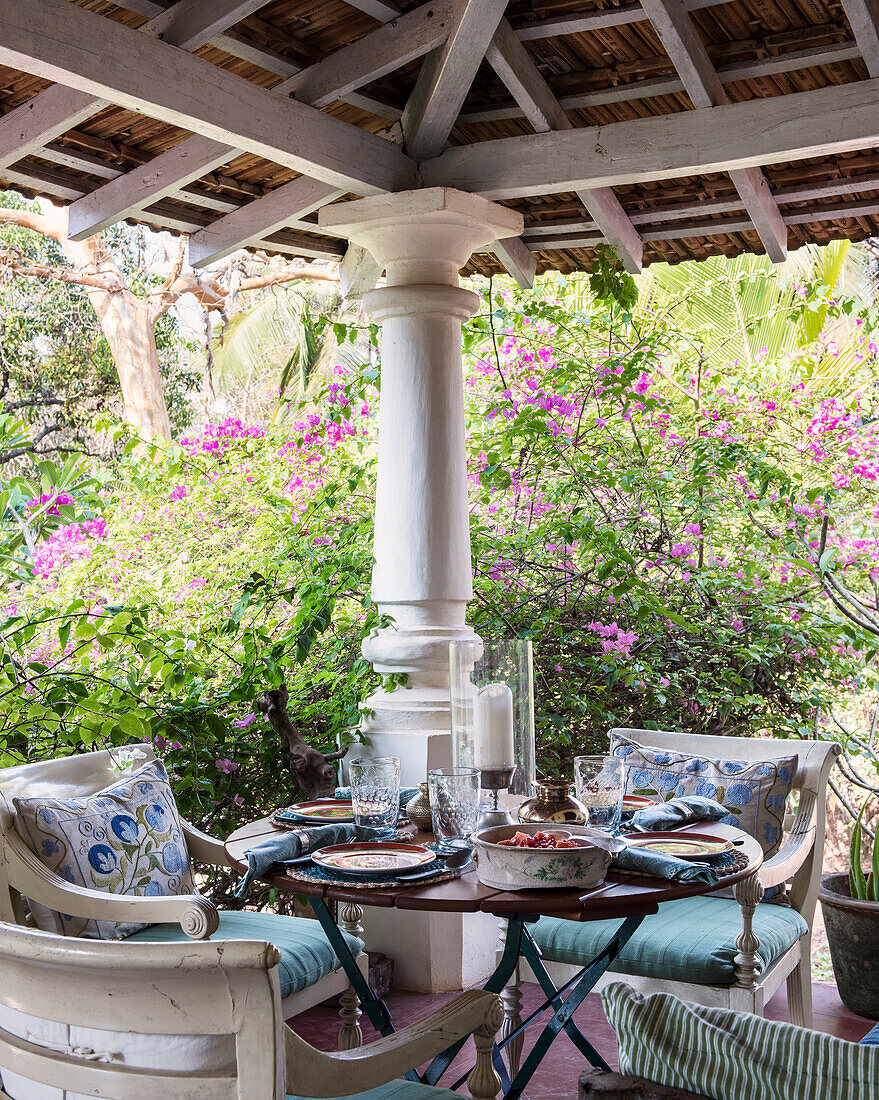 Terrace with seating area and view of the flowering garden