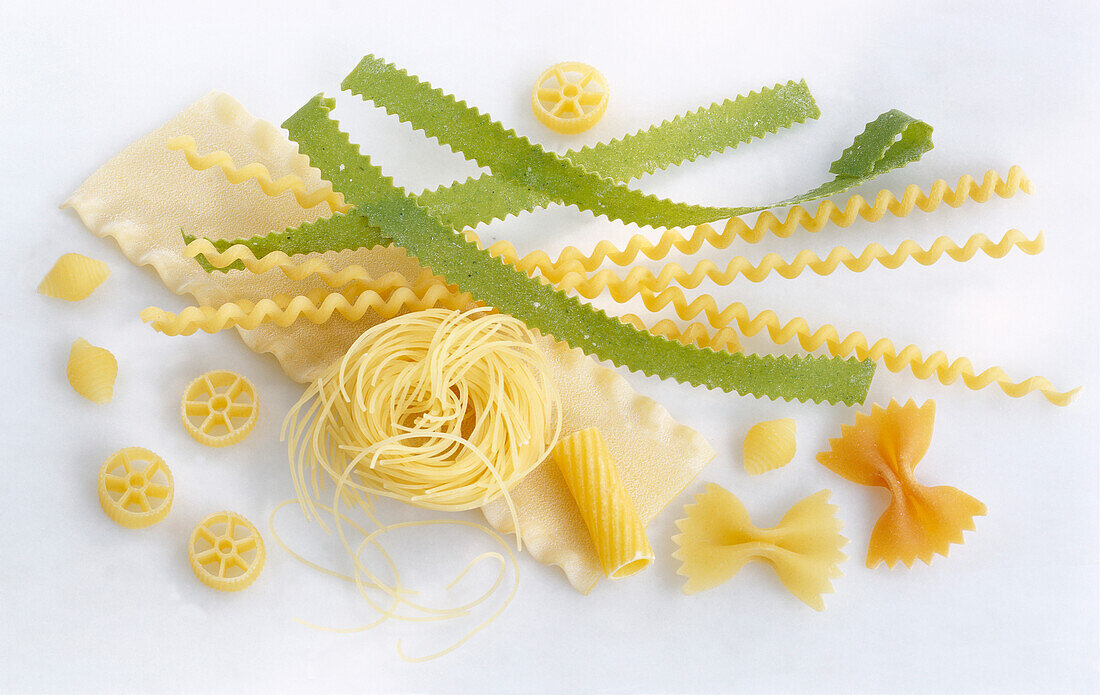 Different kinds of noodles on a white background