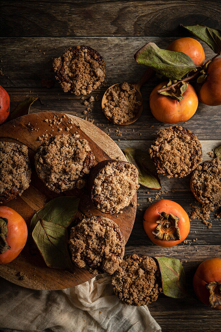 Persimmon Muffins in a rustic kitchen, with fresh persimmons