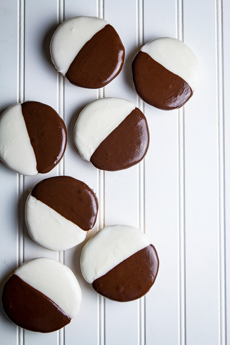 Black and White Cookies on a wooden white background