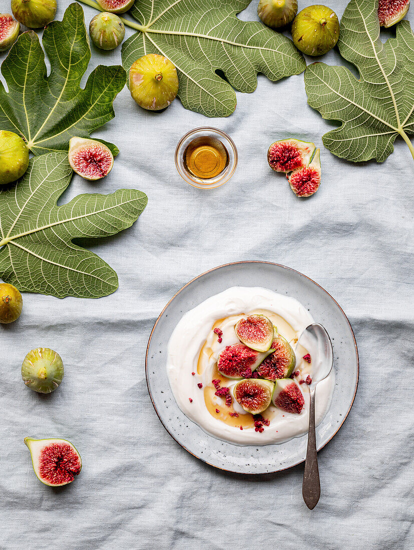 Plate of yogurt with figs on a table