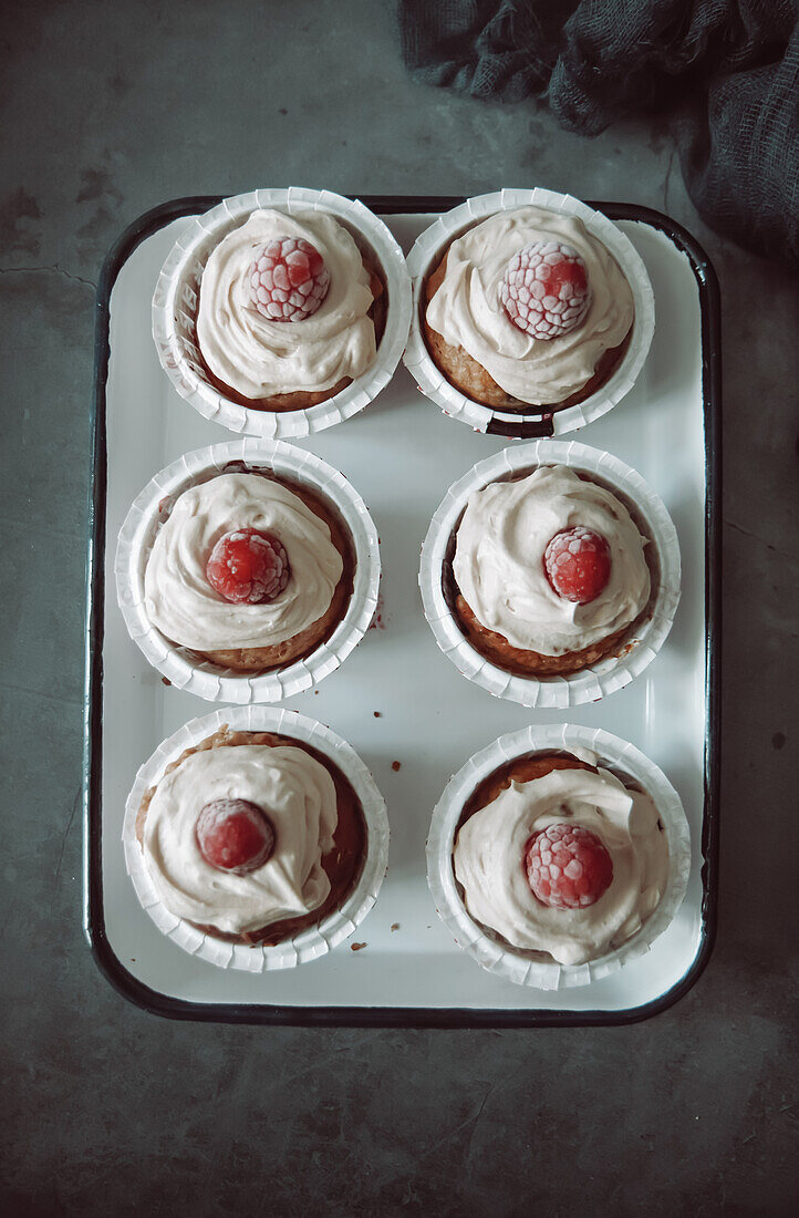 Cupcakes with frosting and raspberry on top
