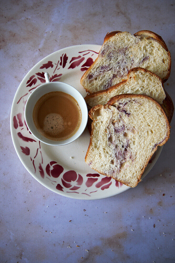 Brioche bread with blueberries served with a cup of espresso