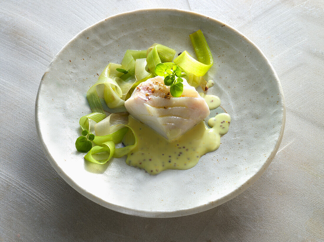 Steamed cod with leeks and sauce