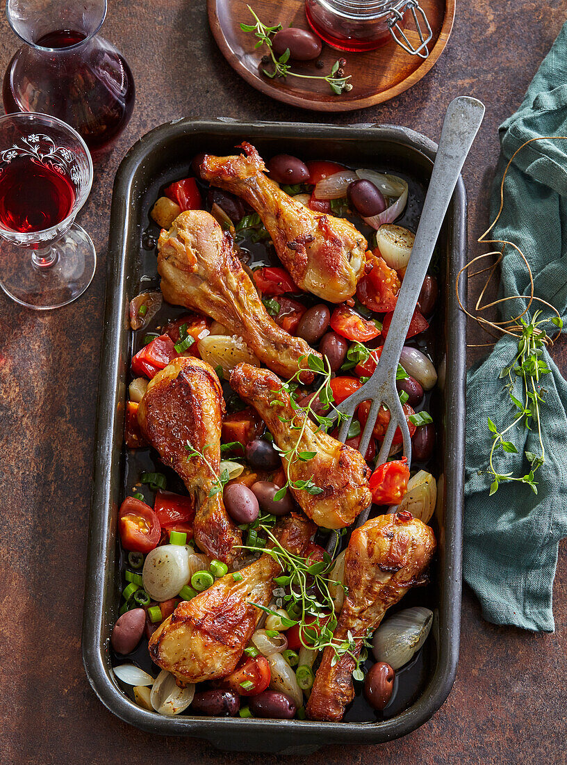 Baked chicken drumsticks with olives and tomatoes