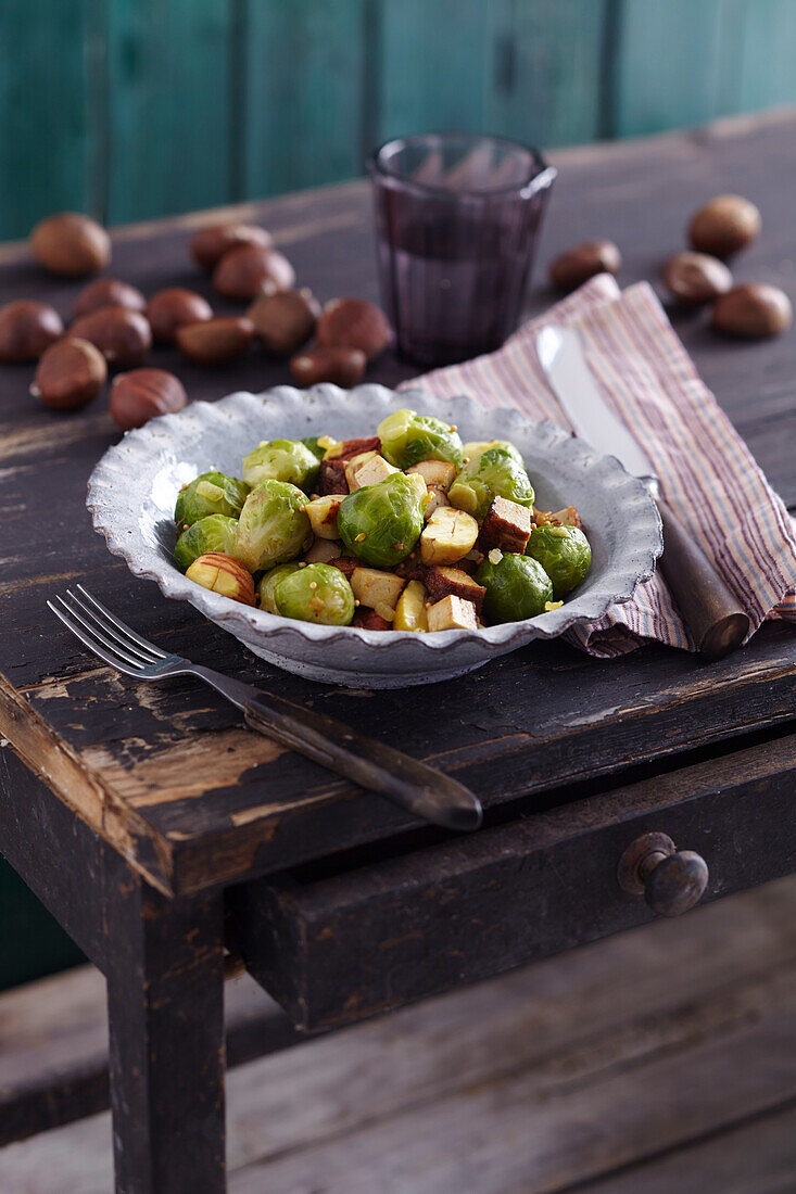Chestnut and Brussels sprouts on a rustic wooden table