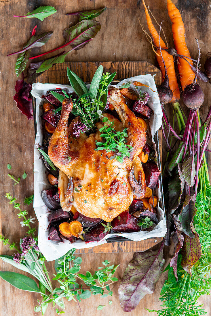 Roasted chicken with beets, carrots, and herbs