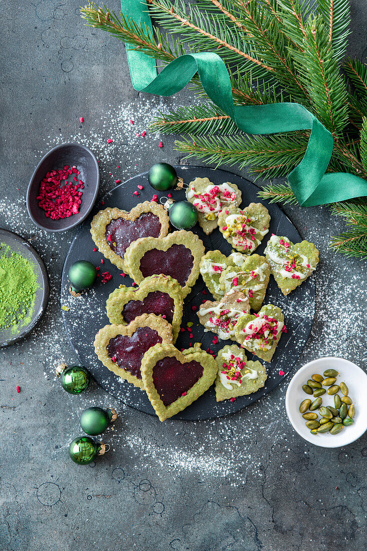 Matcha cookies with raspberry jam and dried raspberries