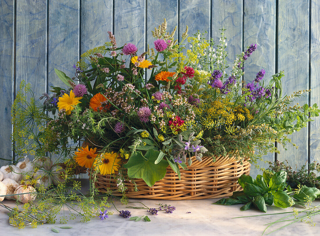 Basket with flowering kitchen herbs